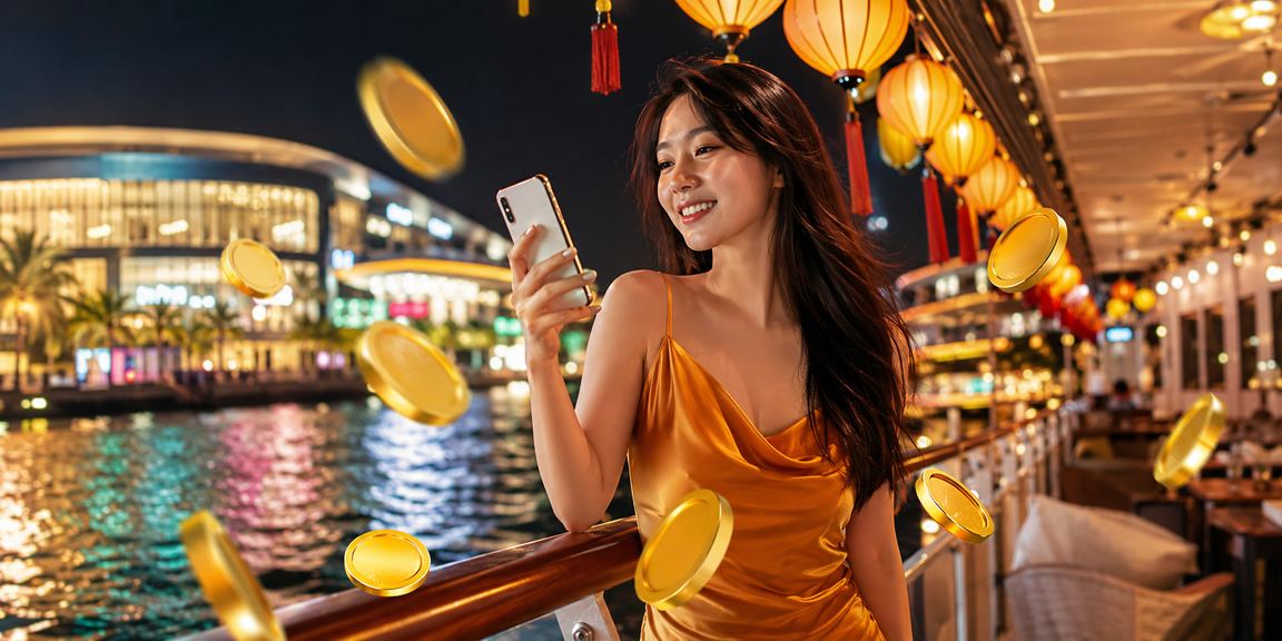 Du khách tận hưởng đêm hội chợ đêm Phú Quốc trong khi theo dõi kết quả cá cược trên điện thoại